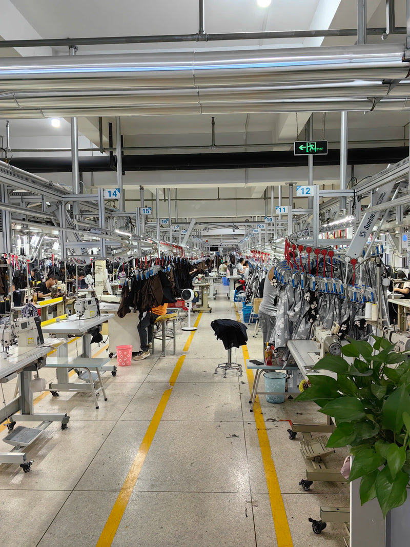 Panoramic wide view of BENTA assembly sewing workshop, production lines, sewing stations and workers assembling knitwear apparel for OEM orders.